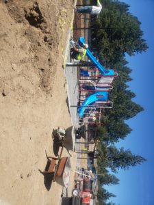 A playground with a slide under construction.