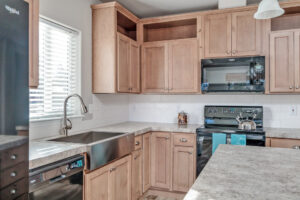 A kitchen with wooden cabinets and a sink at The Pines.