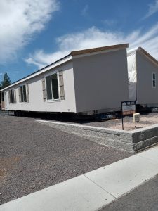 A brand new manufactured home on gravel.