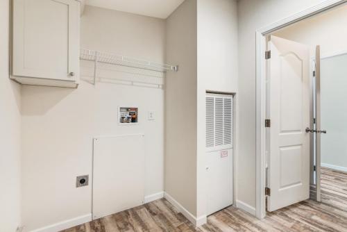 A small room with a closet and a door.