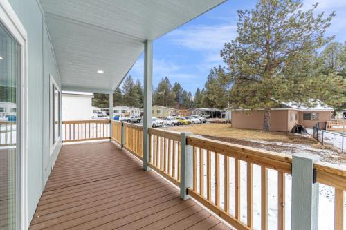 The deck of a home with snow on the ground.