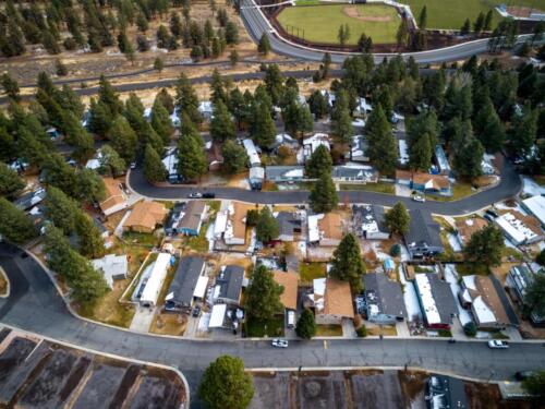 An aerial view of an rv park surrounded by trees.