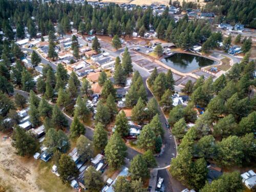 An aerial view of an rv park in the forest.