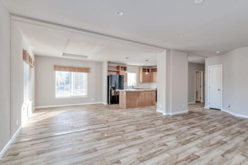 An empty living room with hardwood floors.